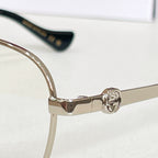 Gucci eyeglasses frame close-up with gold temples and clear lenses