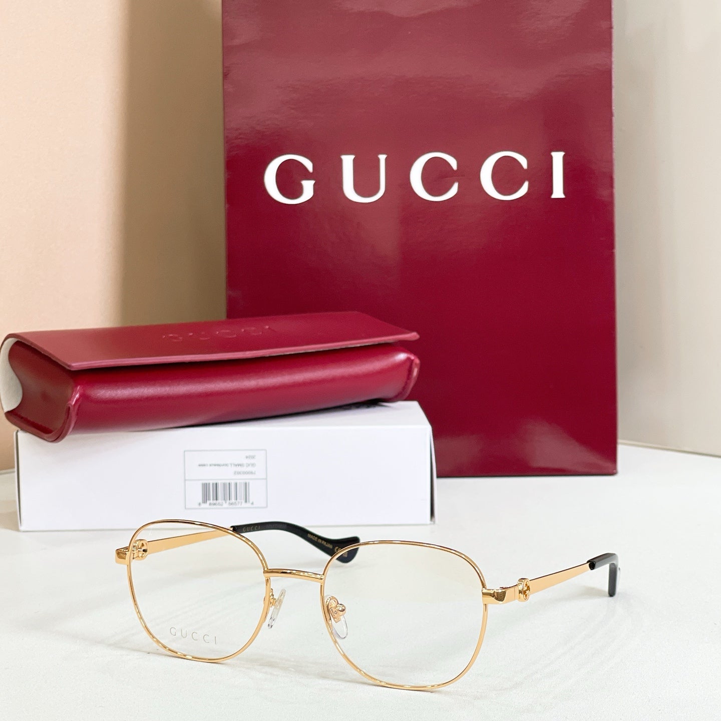 Gucci eyeglasses with gold round frame and black temple tips