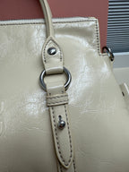 Ivory leather handbag shoulder strap with metal ring and stitched attachment tabs