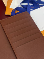Louis Vuitton brown leather card holder, textured surface with stitched card rows.