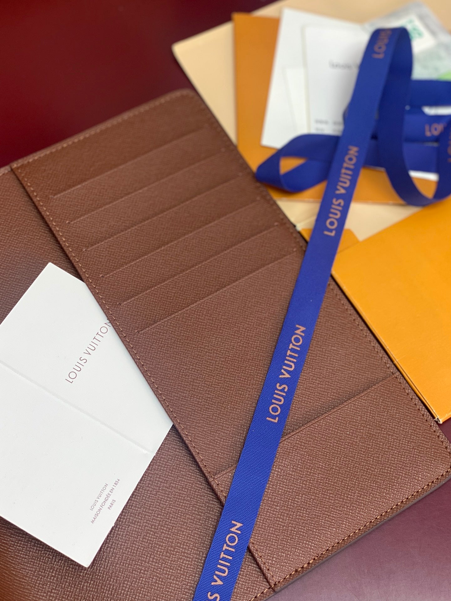Louis Vuitton small brown leather card case with multiple interior card slots