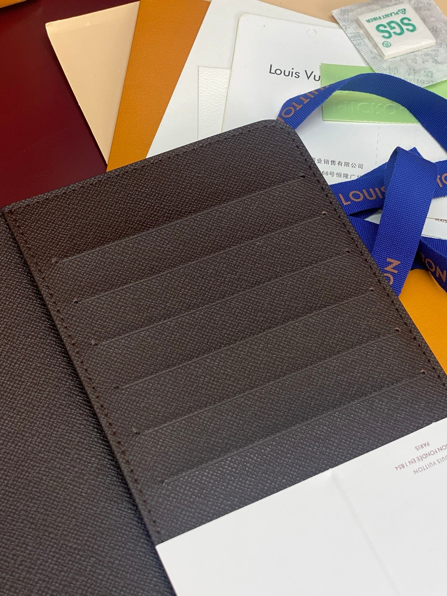 Louis Vuitton dark wallet interior with card slots and stitched lining