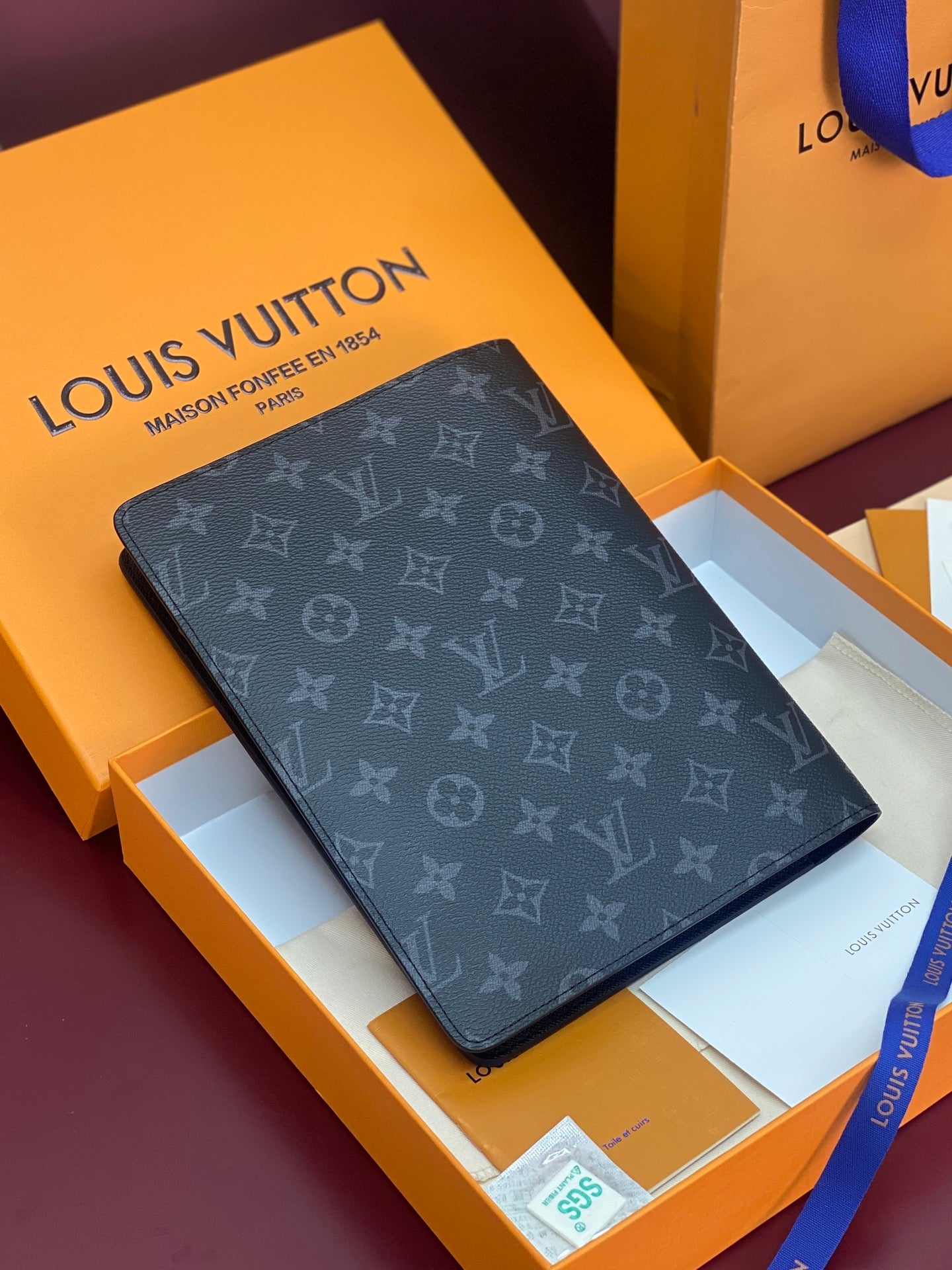 Louis Vuitton small bag with dark monogram canvas, foldover flap and edge detail