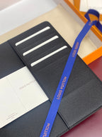 Louis Vuitton small card holder with textured dark lining and three horizontal slots