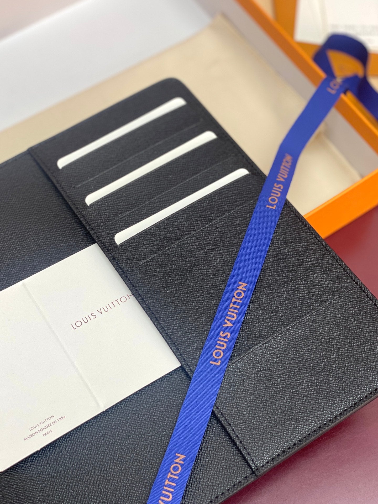 Louis Vuitton small card holder with textured dark lining and three horizontal slots