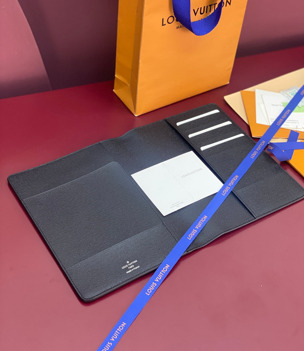 Louis Vuitton small wallet with snap-open flap, card slots and blue logo ribbon