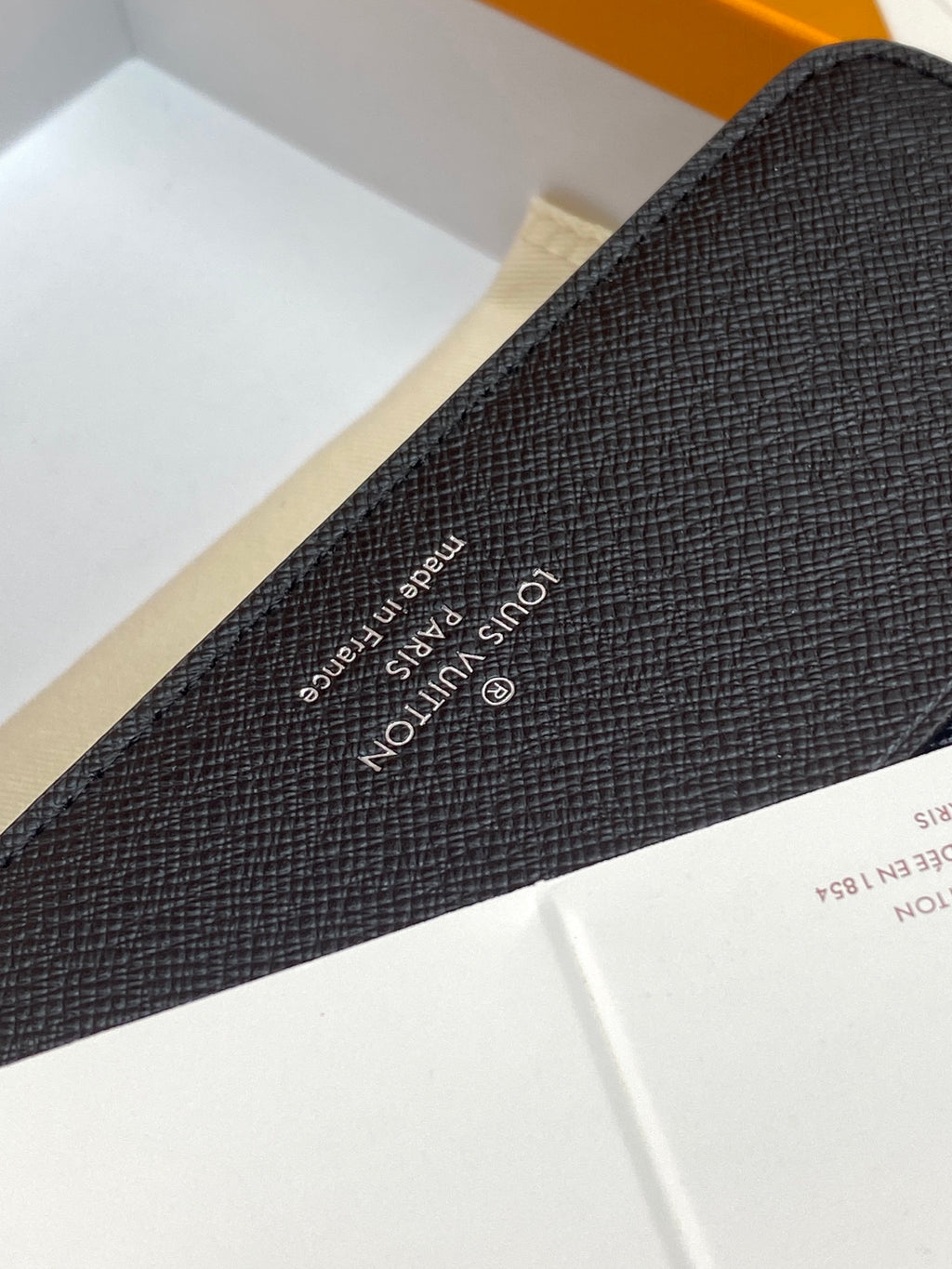 Louis Vuitton monogram card holder, dark textured leather with stamped logo