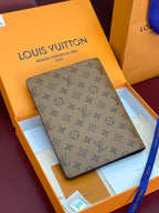 Louis Vuitton small bag in tan monogram canvas, rectangular with rounded corners.