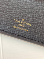 Louis Vuitton embossed wallet, dark textured leather surface