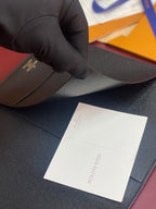 Louis Vuitton textured wallet, dark blue, held with white paper label