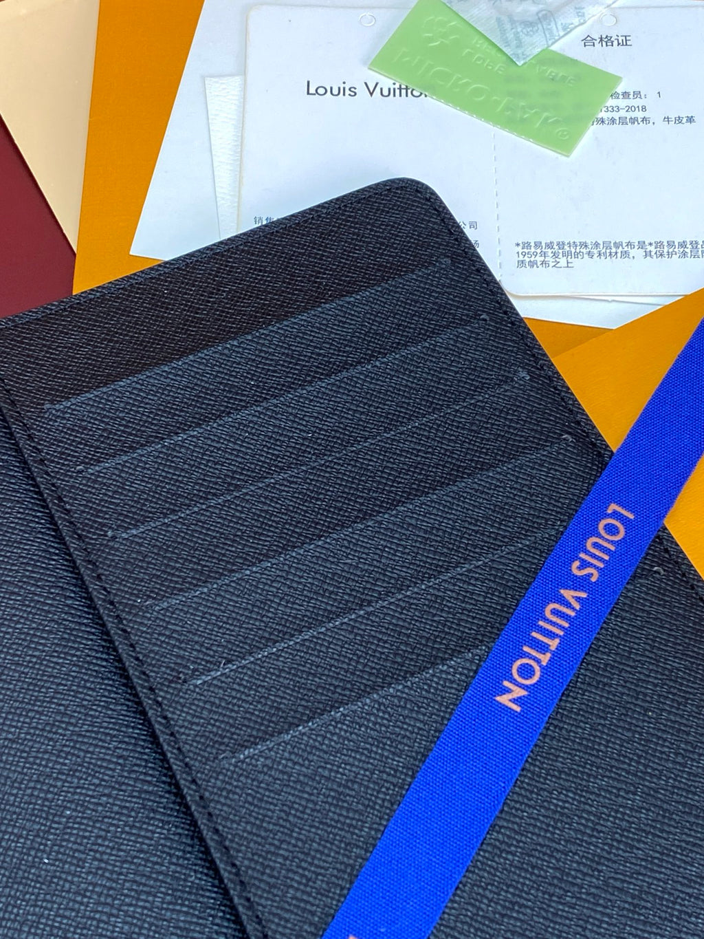 Dark blue Louis Vuitton fabric card holder with horizontal stitched panels