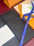 Louis Vuitton small bag open, dark textured card slots with paper inside