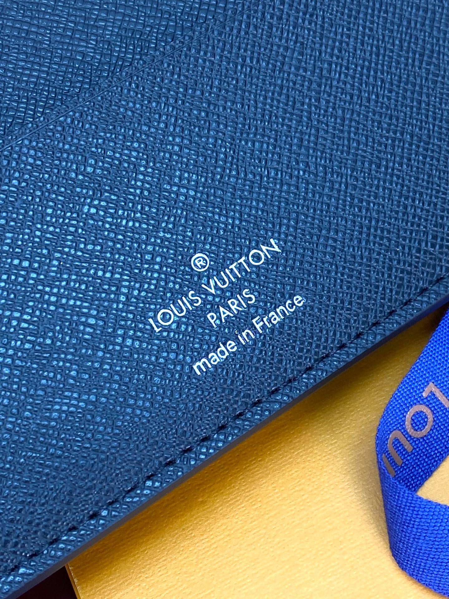 Blue textured leather card holder with Louis Vuitton logo and stitching
