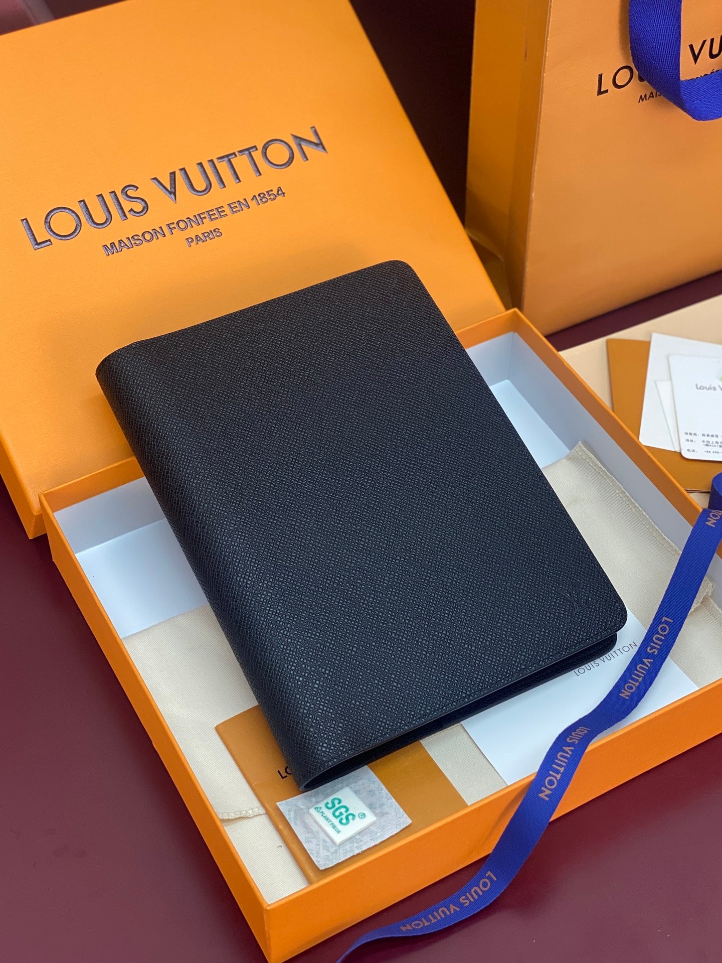 Louis Vuitton leather wallet in dark finish, slim rectangular profile