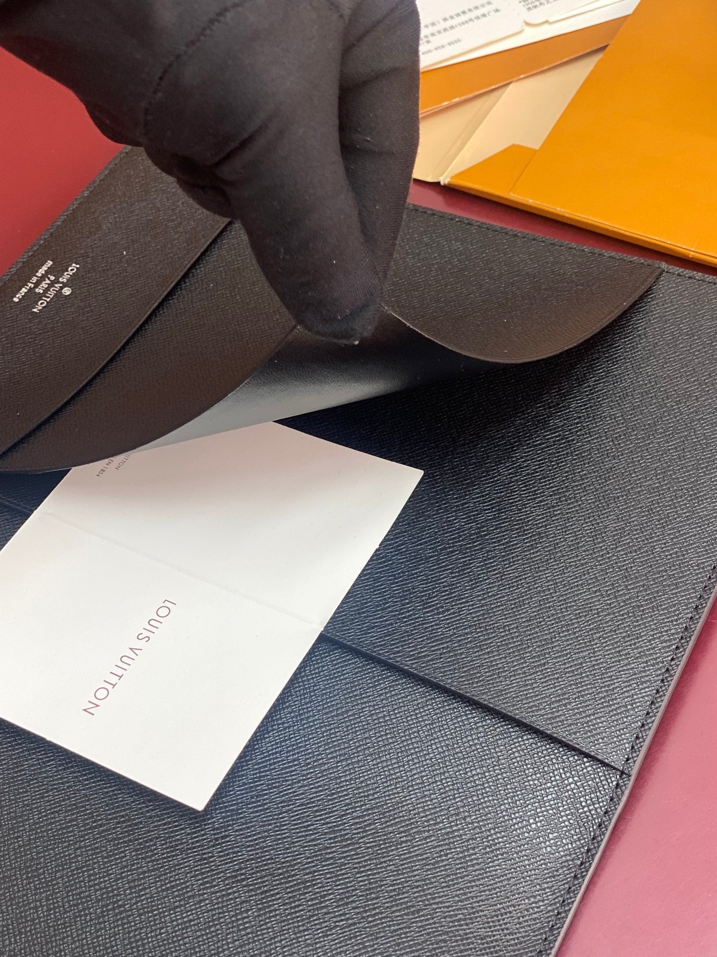 Louis Vuitton dark leather card holder with open pocket and receipt card