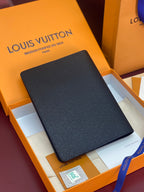 Louis Vuitton small bag with dark textured leather finish, front view in box