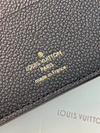 Dark embossed leather small bag with logo medallion and 'made in France'