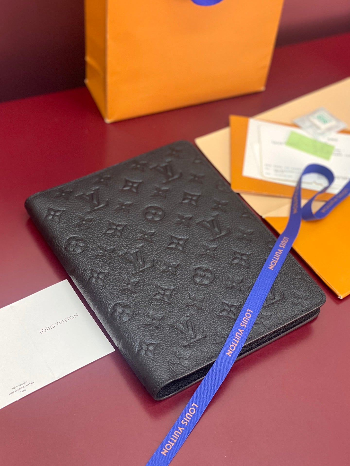 Dark monogram embossed leather small bag with flap and ribbon pull