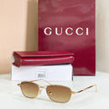 Gold-tone aviator eyeglasses with tinted light brown lenses and clear temple tips