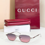 Gold-tone aviator eyeglasses with pink tinted lenses and metal frame