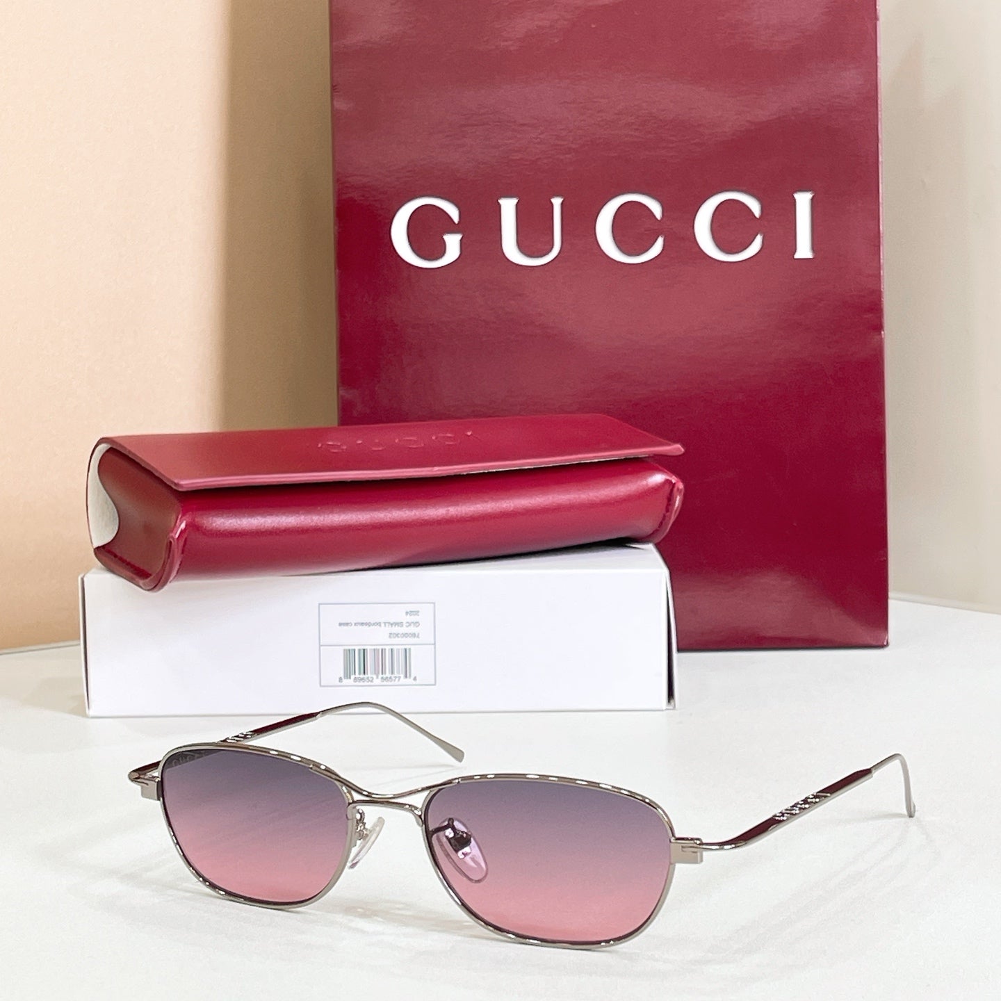 Gold-tone aviator eyeglasses with pink tinted lenses and metal frame