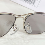 Close-up of gold-tone aviator eyeglass frame and clear hinge detail