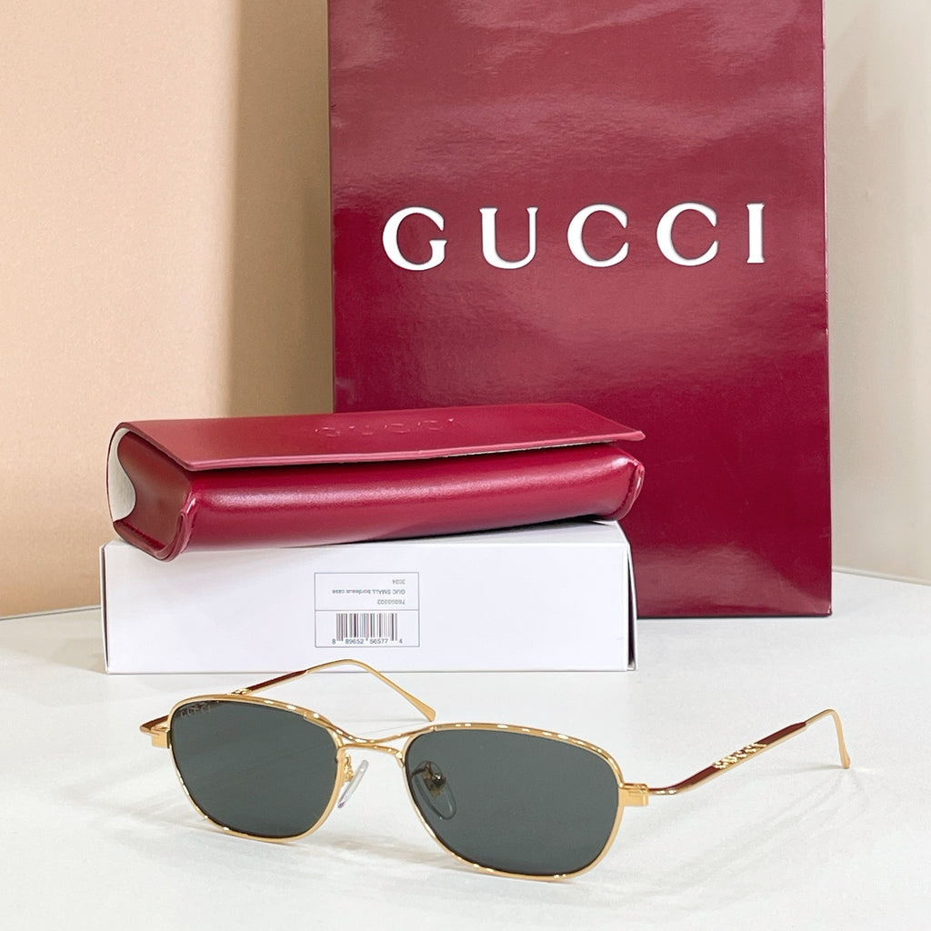 Gold-tone aviator eyeglasses with dark tinted lenses and thin metal frame