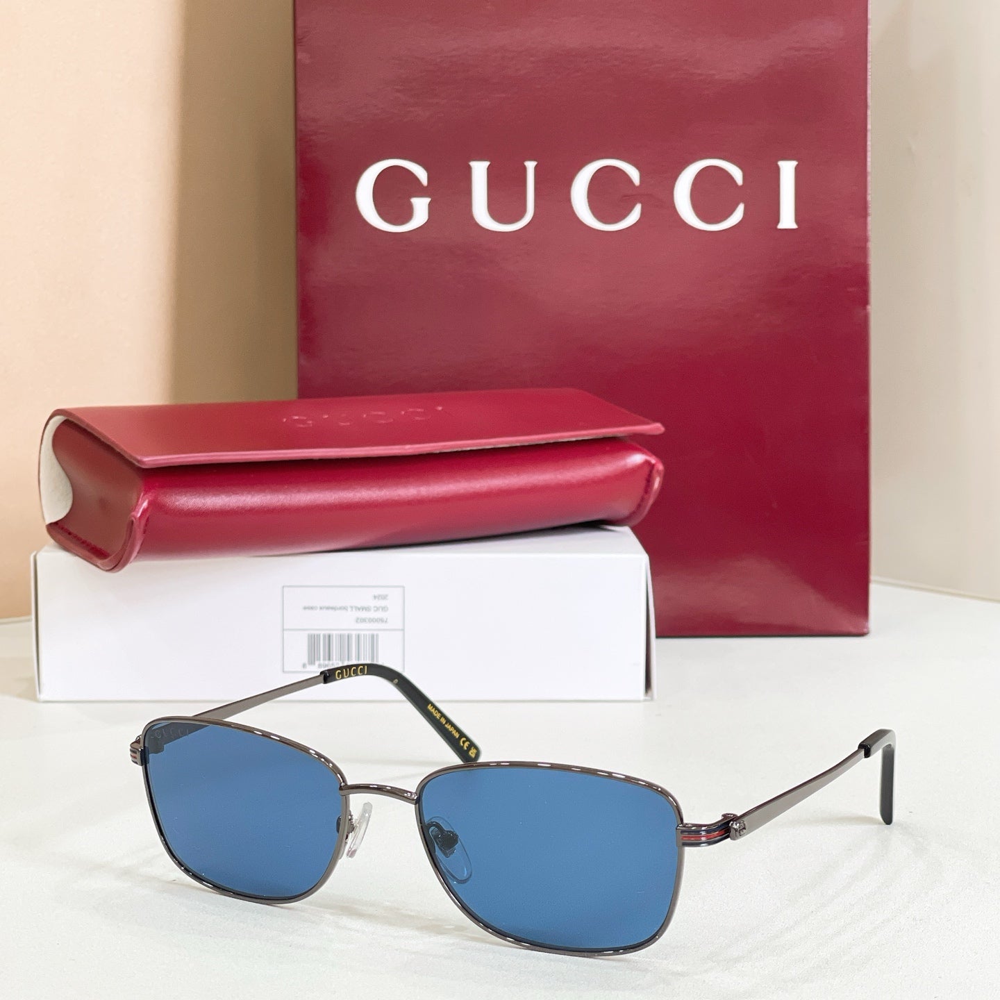 Silver-tone metal sunglasses with blue tinted lenses and slender temple arms