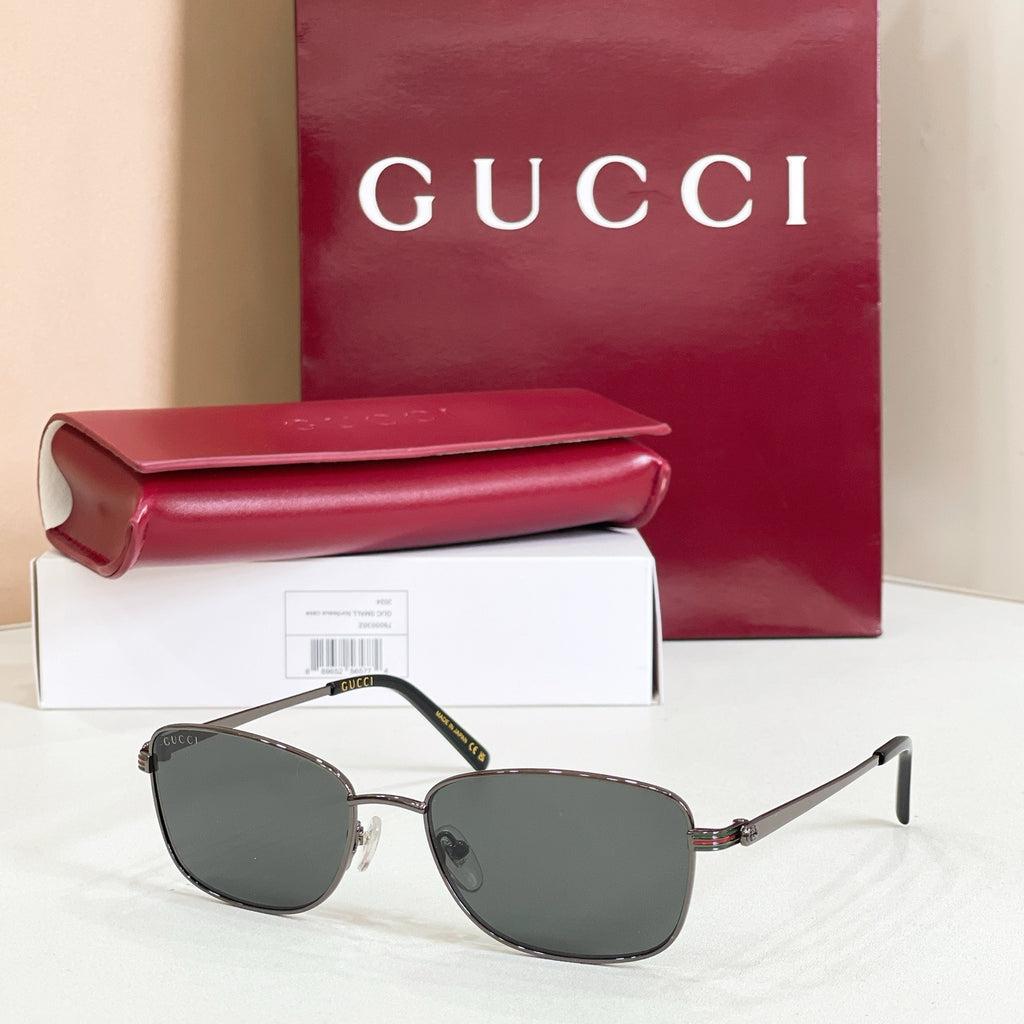 Silver-tone metal sunglasses with dark gray tinted lenses and side hinge detail