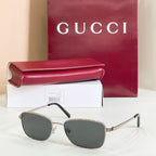 Silver-tone metal sunglasses with dark gray tinted lenses and slim temple arms