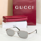 Silver-tone metal sunglasses with light gray tinted lenses and angled temple tips