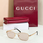 Gold-tone metal sunglasses with light tinted lenses and slim temple arms