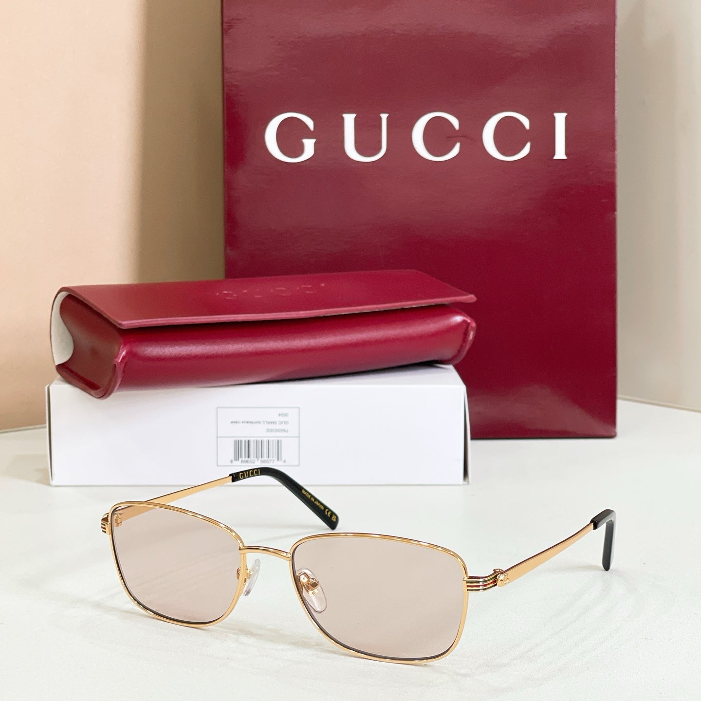 Gold-tone metal sunglasses with light tinted lenses and slim temple arms