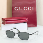 Silver-tone metal sunglasses with dark gray tinted lenses and low-profile frame