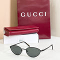 Gucci sunglasses with black metal frame and dark gray lenses