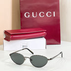 Gucci sunglasses with black metal frame and dark gray lenses