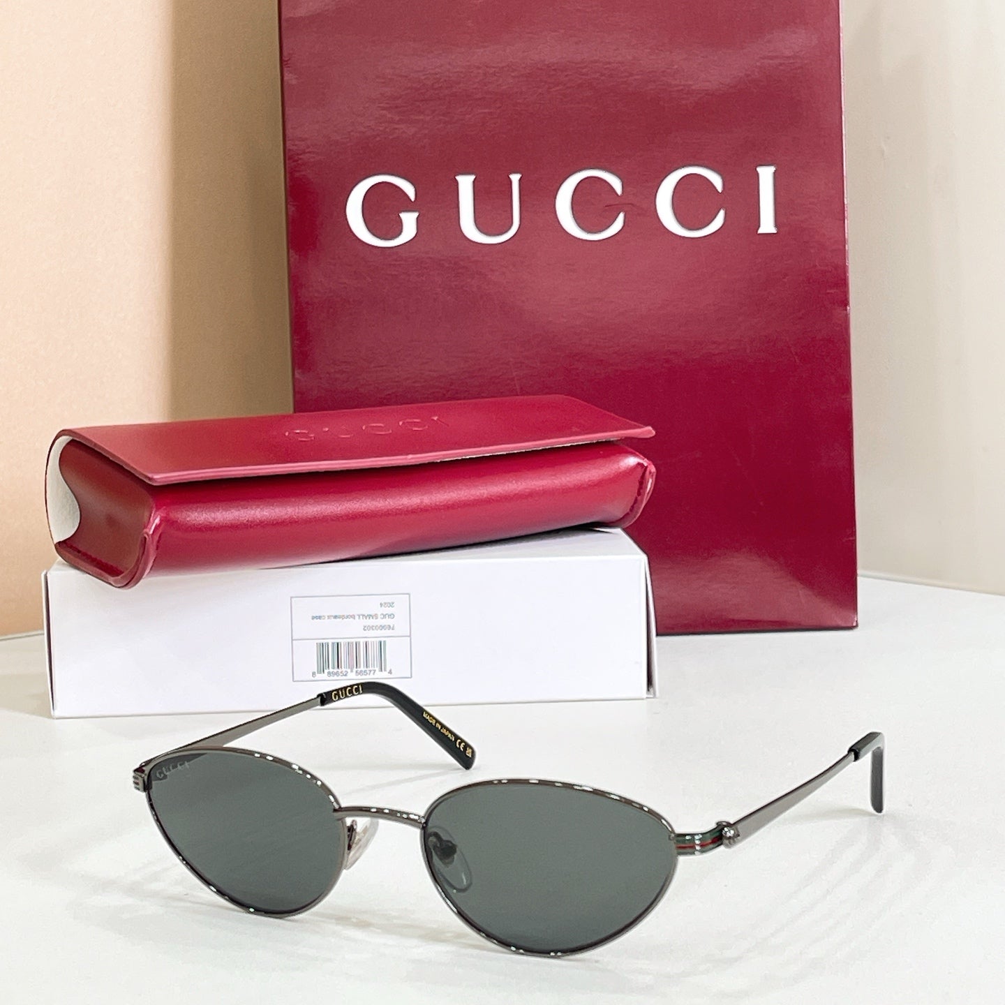 Gucci sunglasses with black metal frame and dark gray lenses