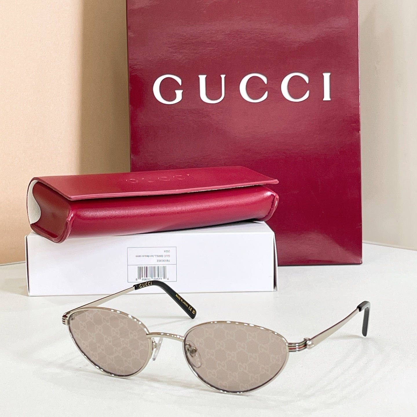 Gucci sunglasses with gold metal frame and reflective taupe lenses