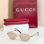 Gucci sunglasses with gold metal frame and light beige lenses
