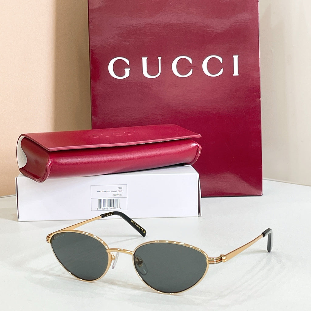 Gucci sunglasses with gold metal frame and dark blue lenses