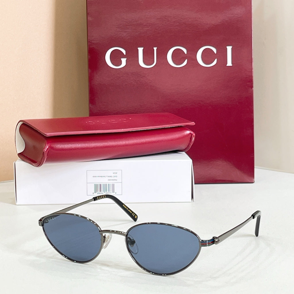 Gucci sunglasses with silver metal frame and blue-tinted lenses