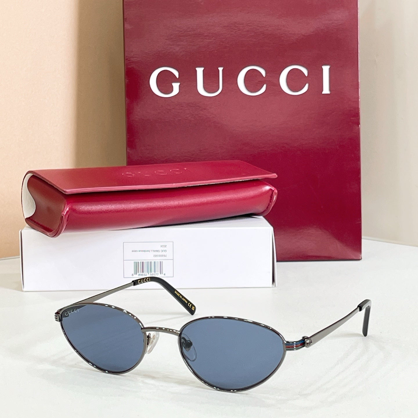 Gucci sunglasses with silver metal frame and blue-tinted lenses