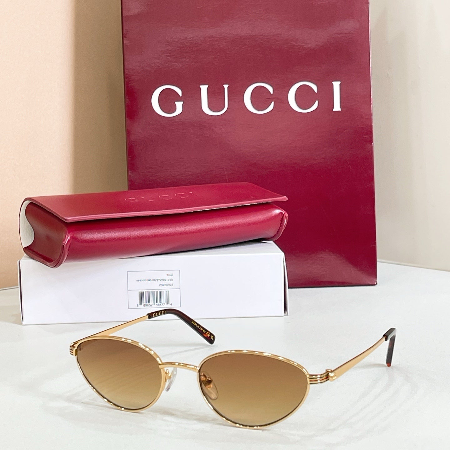 Gucci sunglasses with gold metal frame and tan lenses