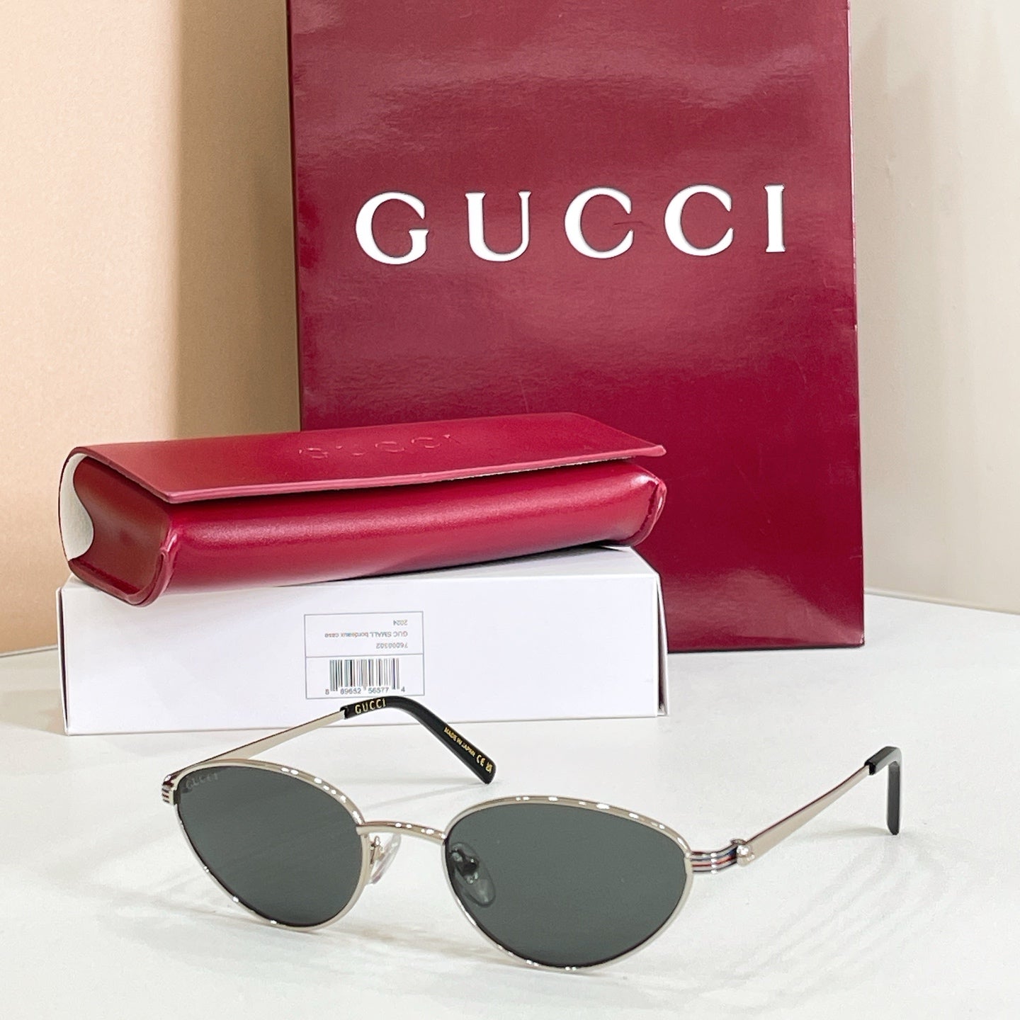 Gucci sunglasses with silver metal frame and dark gray lenses