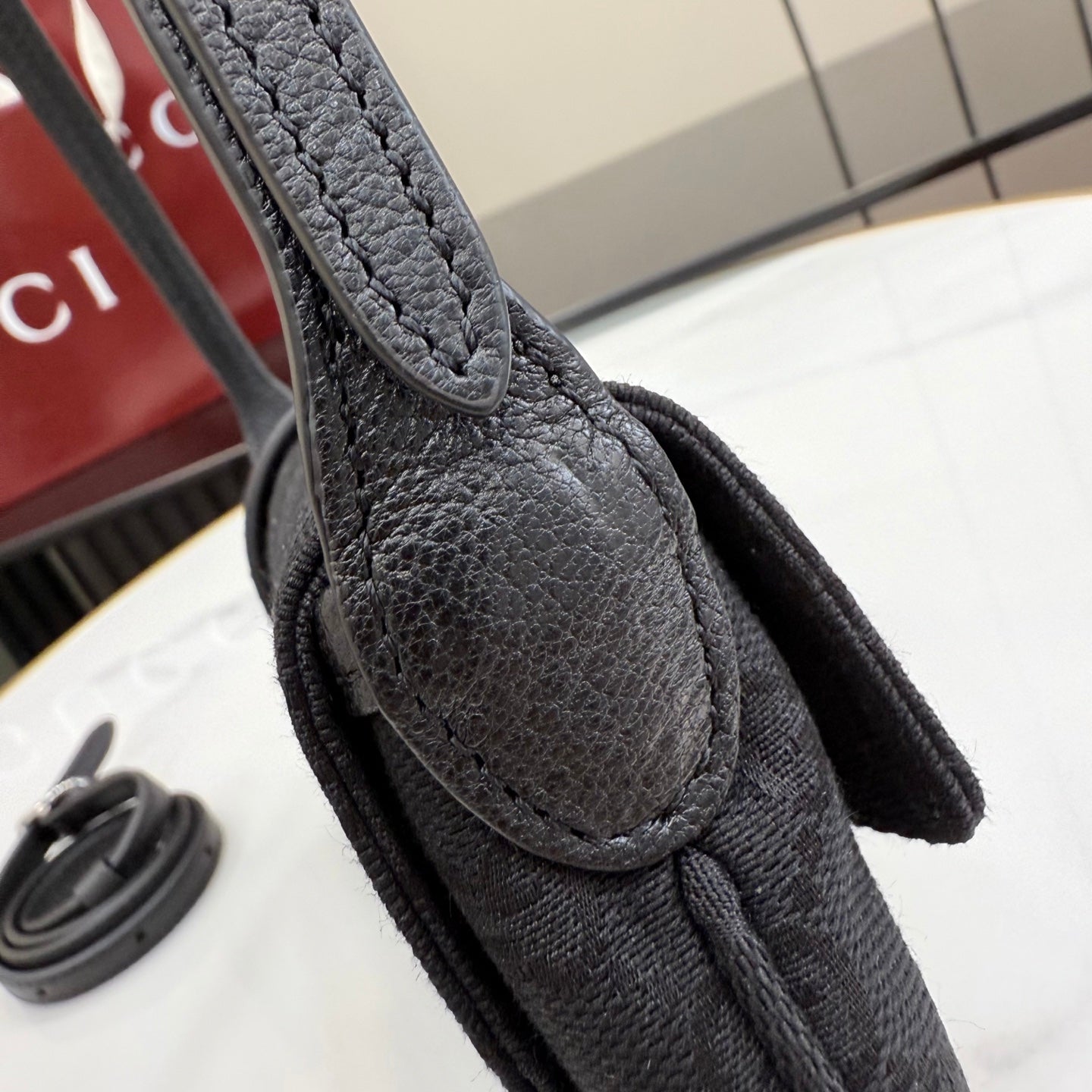 Gucci bag handle, textured black leather with teardrop-shaped connector