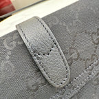 Gucci bag detail, light gray logo canvas with stitched leather trim and tab