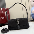 Black Gucci shoulder bag with monogram pattern, flap front, and chain latch detail.