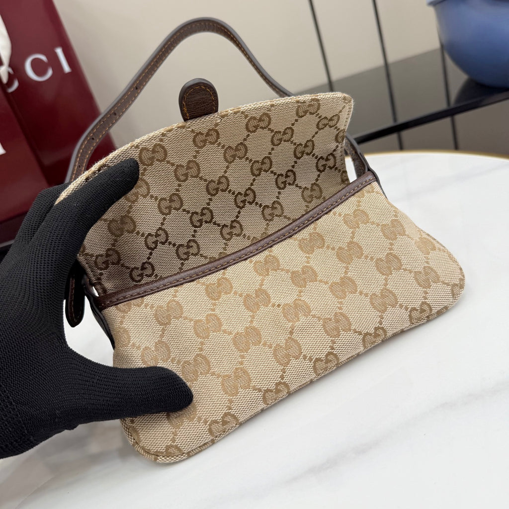 Beige GG-pattern shoulder bag angled view with dark brown strap and flap detail