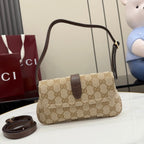 Beige GG-pattern handbag with dark brown flap, top handle, and gold-tone clasp