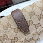 Monogram canvas bag handle with brown leather tab and stitched edge